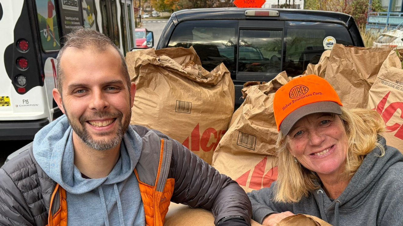 Oscar and Amanda loading leaves into a truck.